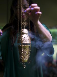 amyra mah preparing incense for ceremony 2024